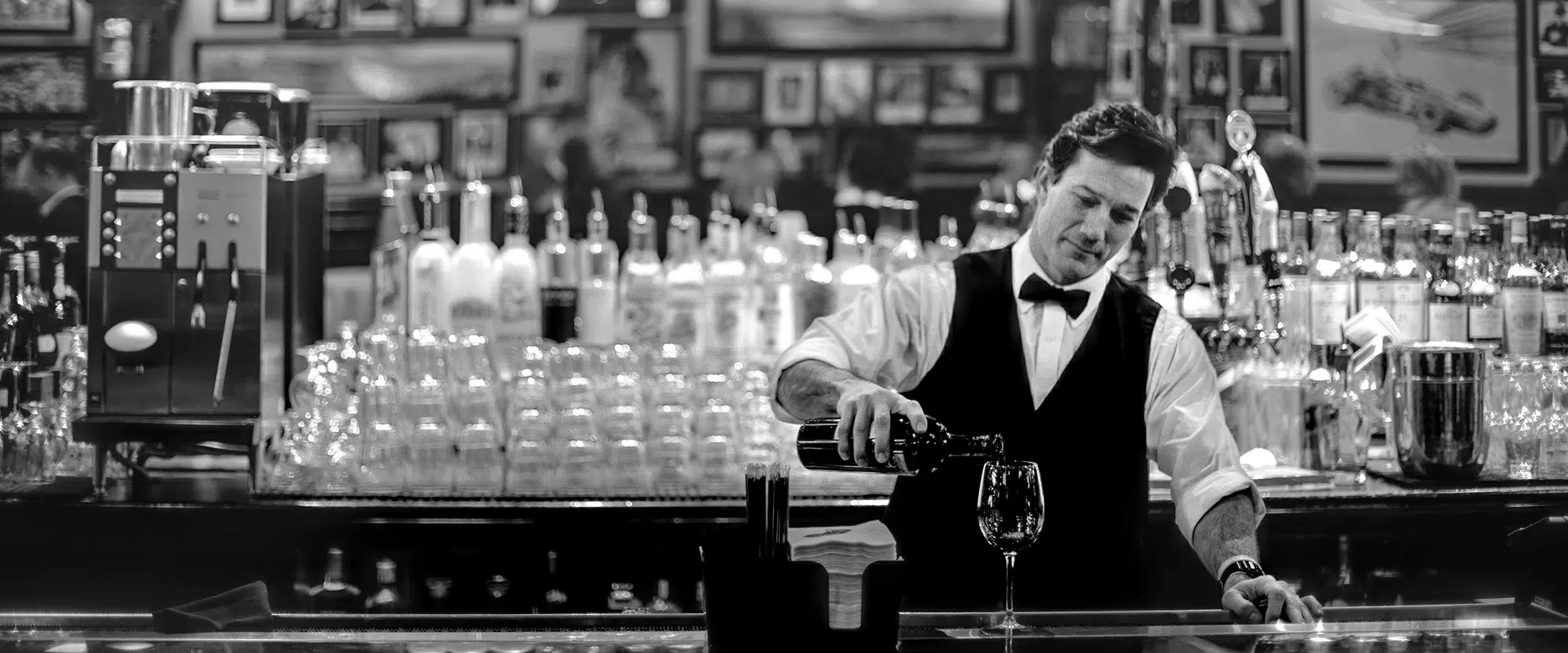 St. Elmo Steak House bartender pouring glass of wine